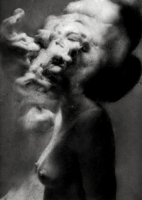Black and white fine art photograph of a nude female figure with one arm braced overhead, her face obscured by a drifting cloud of smoke against a dark background. Unmoored series.