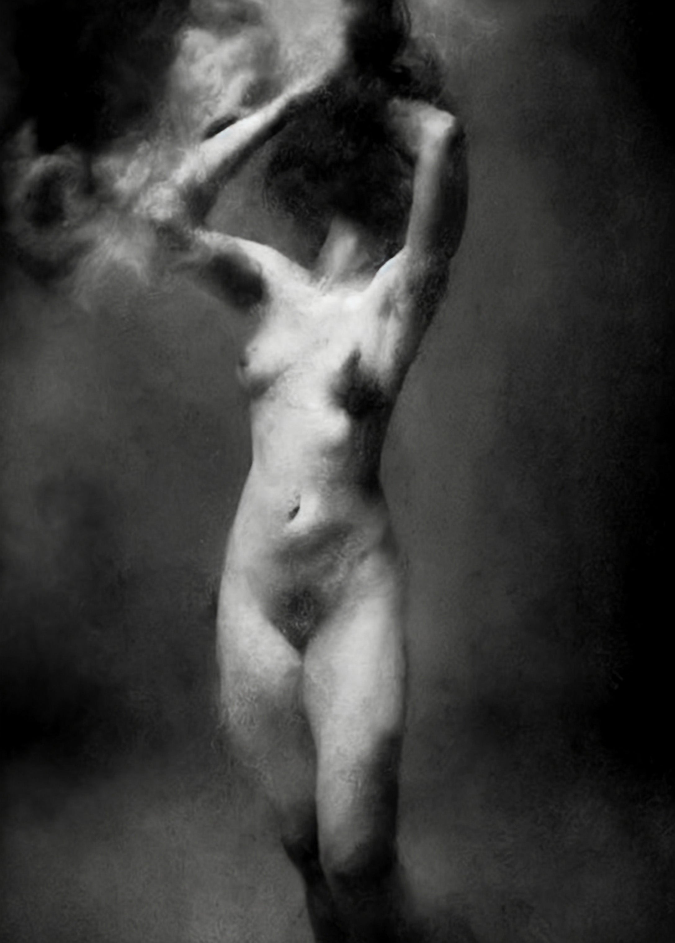 Black and white fine art photograph of a nude female figure in a smoking pose, with smoke blending into a dark, moody background. Unmoored series.