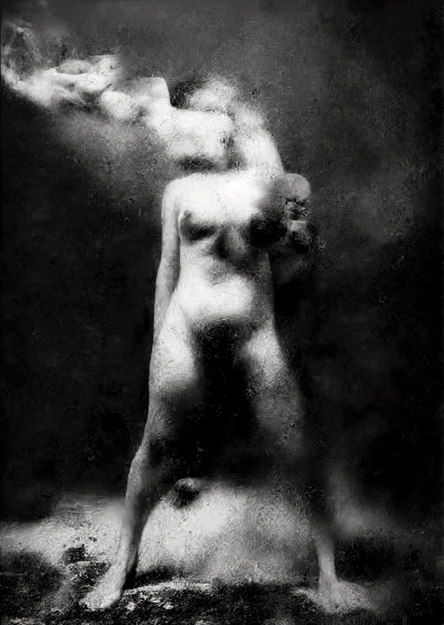 A black and white fine art photograph of a nude female figure standing on a dark, smoky background with light rays hitting her body.  Unmoored series.