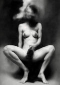 Black and white fine art photograph of a nude female figure standing against a dark textured background, with her head rendered as a surreal melting mass of hair, skin, and abstract forms.  Unmoored series.